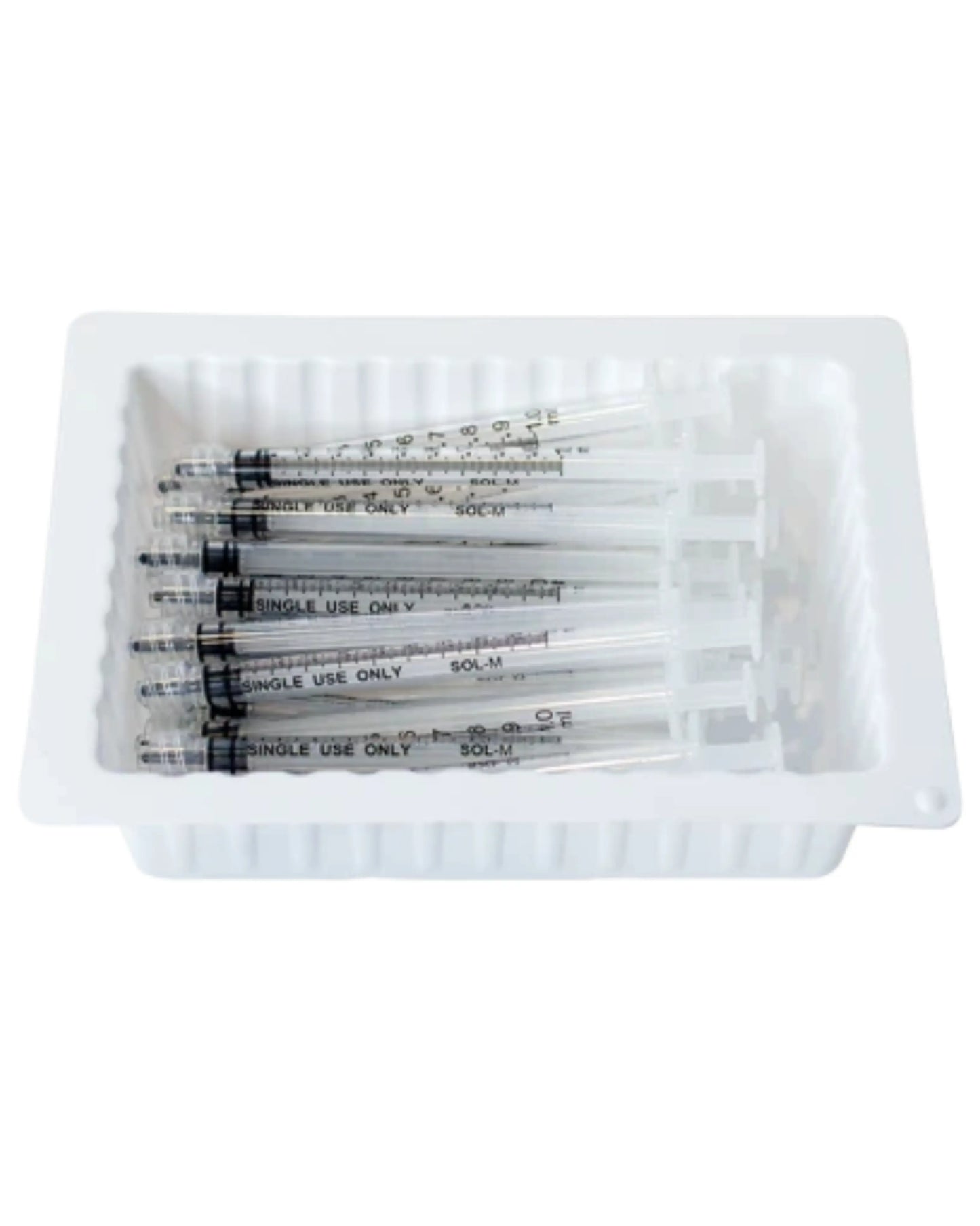 Disposable medical syringes in a white plastic tray, single use, home care supplies