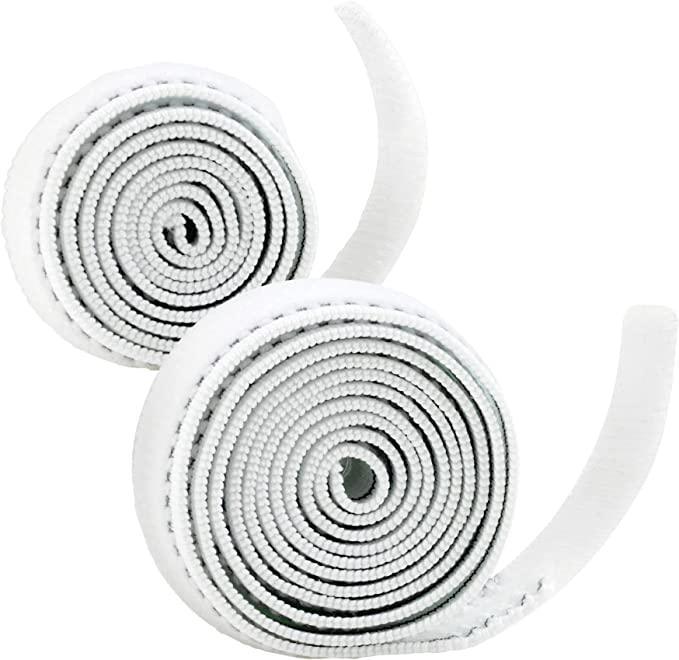 Two white self-adhesive medical bandage rolls, coiled on a white background