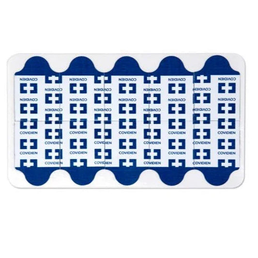 Sheet of blue and white Covidien medical tape dots for wound care or dressing fixation