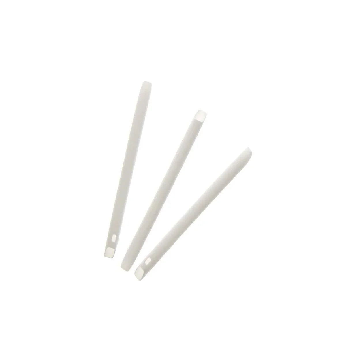 Three white plastic tongue depressors for medical use on white background