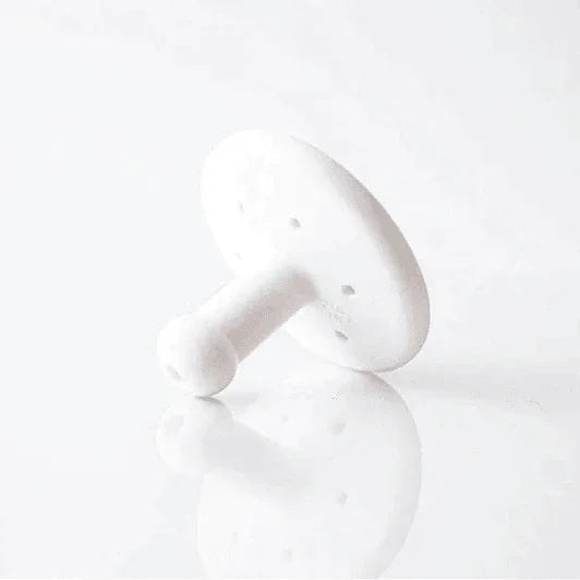 White ceramic facial massage mushroom for skincare on a white background