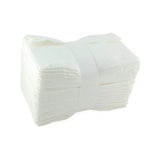 Stack of white disposable medical gauze pads for wound care and first aid