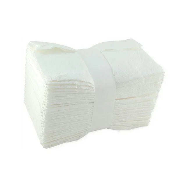 Stack of white disposable medical gauze pads for wound care and first aid