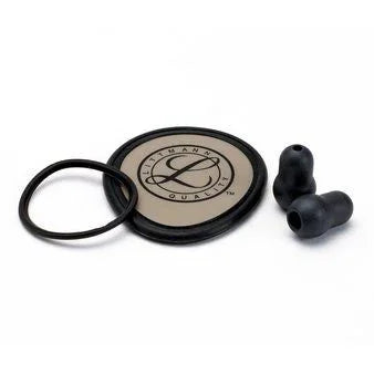 Stethoscope replacement parts kit with diaphragm, eartips, and rubber ring on white background