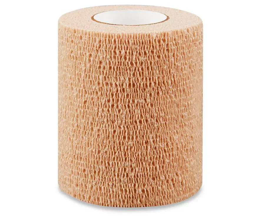 Beige medical cohesive bandage roll for wound care and first aid