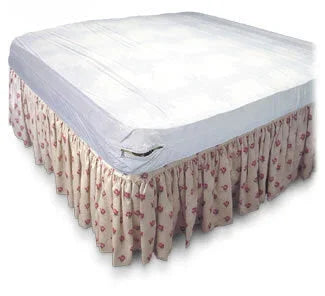 Waterproof mattress protector on bed with floral bed skirt for home care