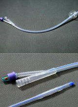 Sterile silicone Foley catheter with balloon, detailed view on textured background, medical supplies.