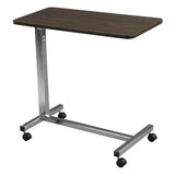 Adjustable overbed table with wheels and dark wood top for home care or hospital use