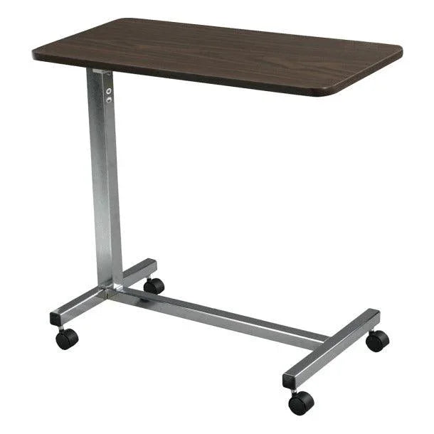 Overbed table with dark wood top and adjustable metal frame on caster wheels