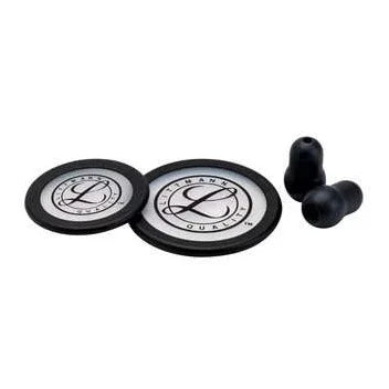 Stethoscope replacement diaphragms and black ear tips on white background