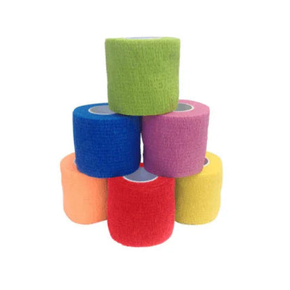 assorted colored self-adhesive medical bandage rolls stacked on white background