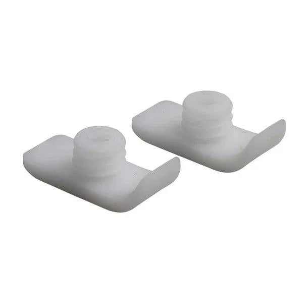 Pair of white plastic medical equipment accessories with threaded tops on a plain background