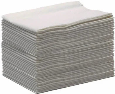 Stack of white disposable medical wipes or gauze pads for home care and first aid