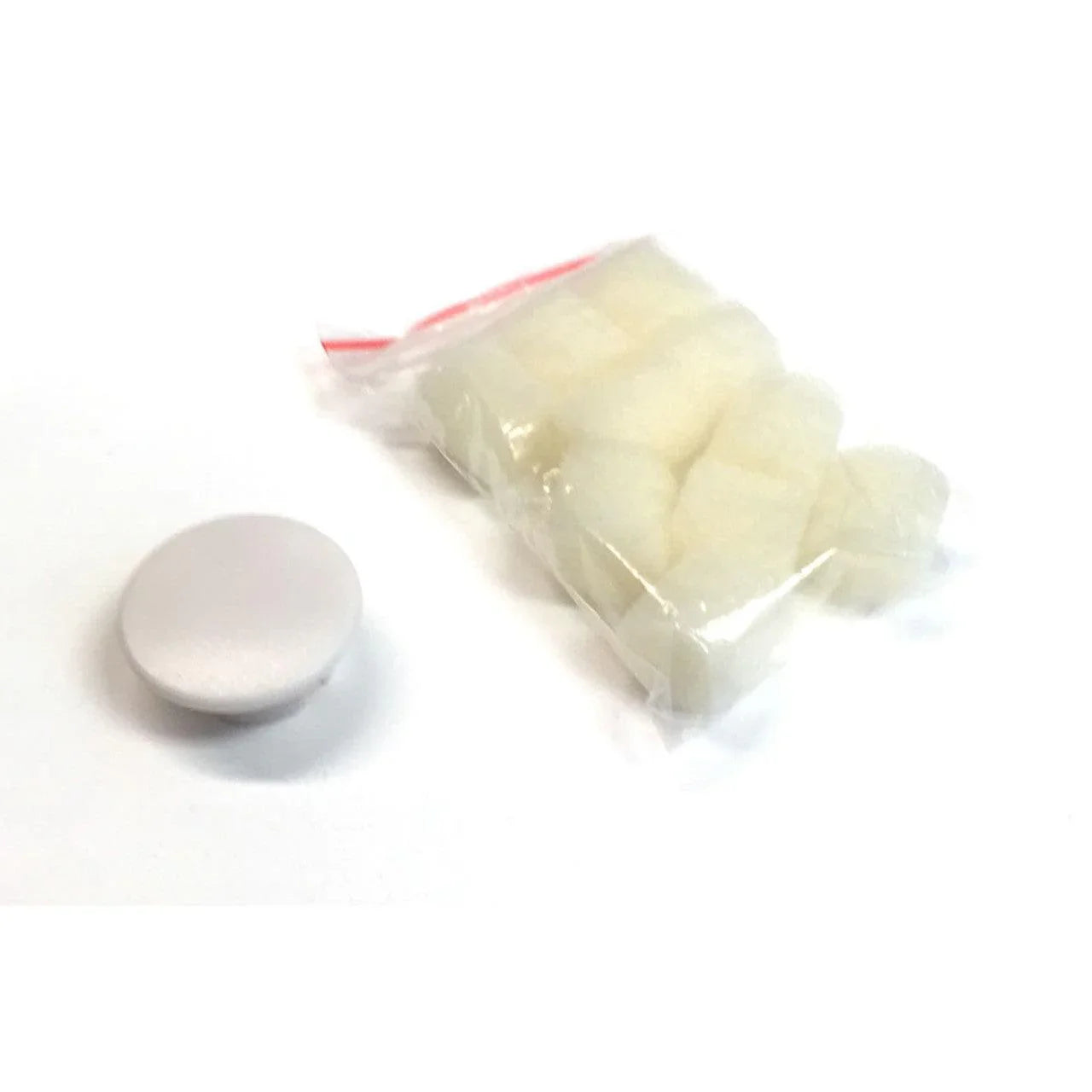 Bag of medical cotton balls with a round plastic container on white background
