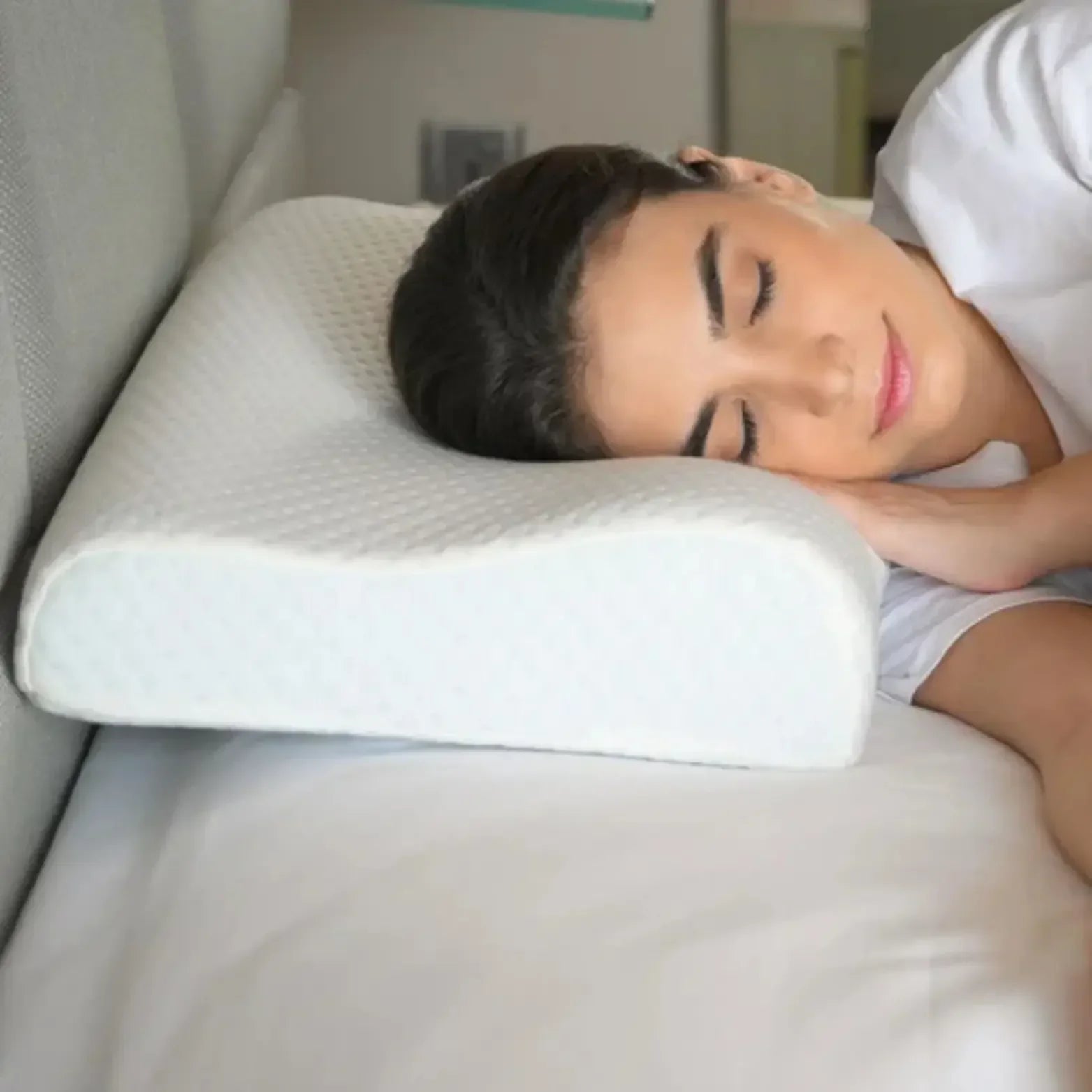 Woman sleeping on ergonomic memory foam orthopedic pillow for neck support