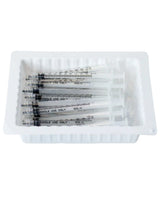 Disposable medical syringes in a white plastic tray, single use, home care supplies