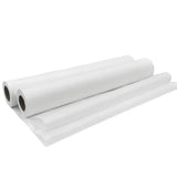 Four white disposable medical exam table paper rolls on a plain background