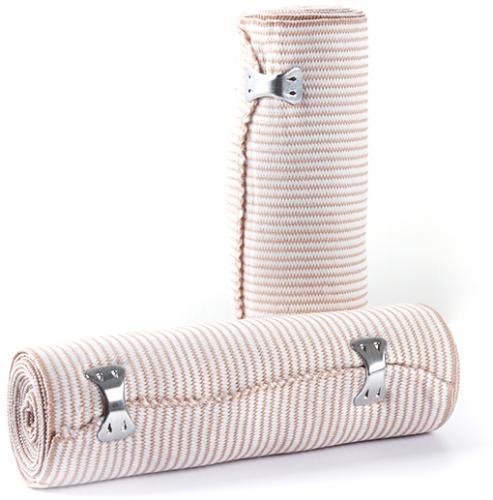 Elastic compression bandages with metal clips for medical use, rolled and standing.