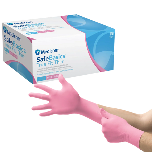 Person putting on pink nitrile medical examination gloves beside glove box