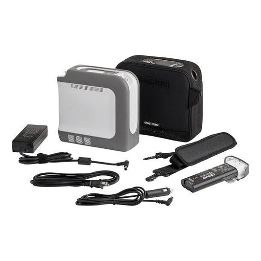 Portable oxygen concentrator kit with carry bag, charger, and accessories on white background