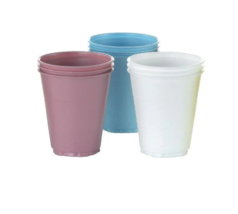 Stacked disposable plastic cups in white, blue, and pink for medical or home care use