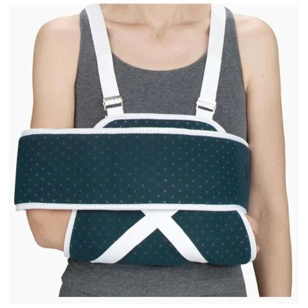 Person wearing orthopedic arm immobilizer brace, medical arm support with straps