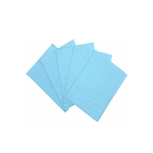 Blue disposable dental bibs or medical tray liners fanned out on a white background