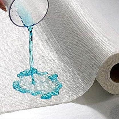 Absorbent medical underpad roll with liquid being poured to show spill protection