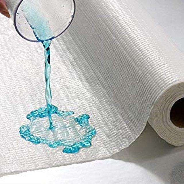 Absorbent disposable bed pad roll with liquid poured to show leakproof protection