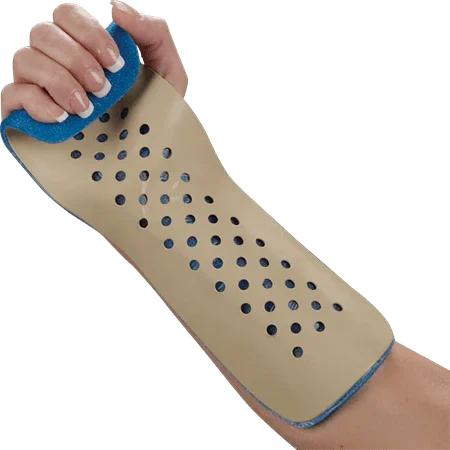 Perforated beige medical wrist and forearm splint support on a person's arm
