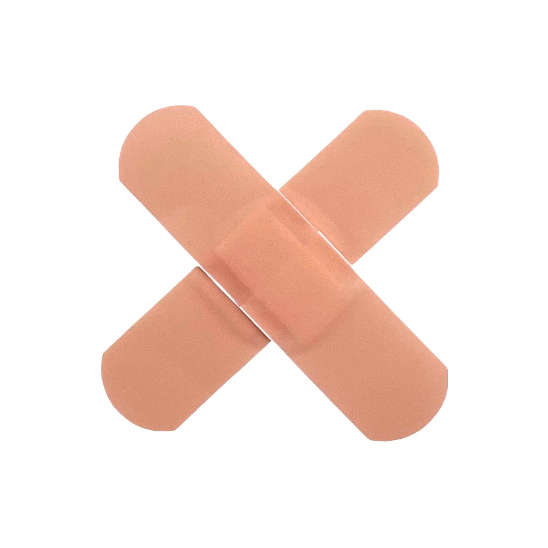 Two adhesive bandages crossed in an X shape on a white background, wound care supplies
