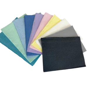 Assorted disposable bibs or towels in various colors for clinical or home care use