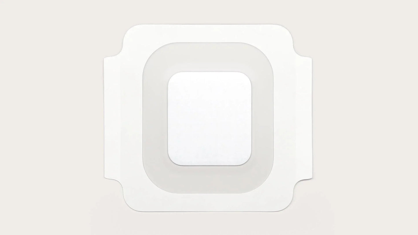 Sterile square adhesive medical bandage with transparent border on light background