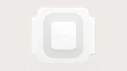 Sterile square adhesive medical bandage with transparent border on light background