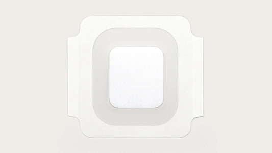 Sterile square adhesive medical bandage with transparent border on light background
