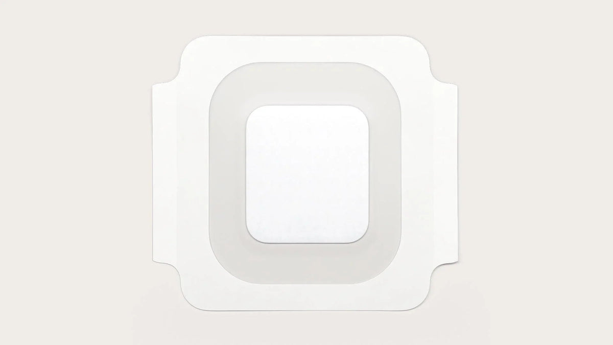 Square medical adhesive wound dressing pad on neutral background