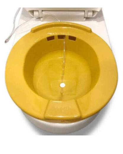 Yellow plastic sitz bath basin with water hose for home care and personal hygiene