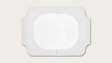 Sterile rectangular medical adhesive dressing with central absorbent pad on white background