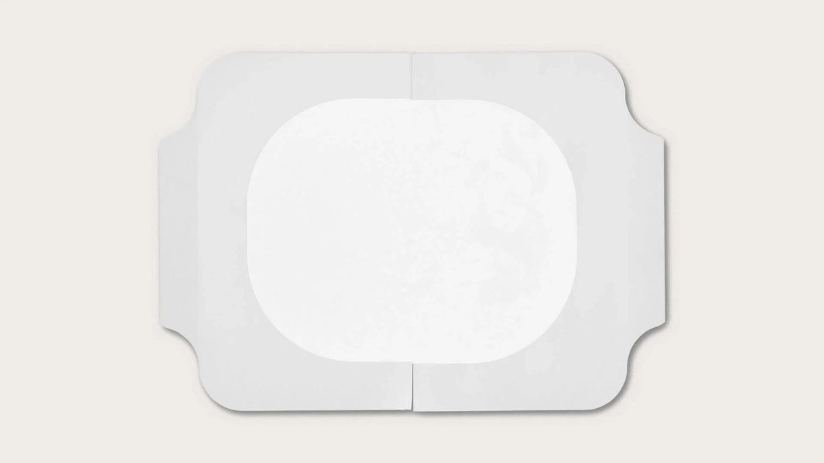 Sterile rectangular medical adhesive dressing with central absorbent pad on white background