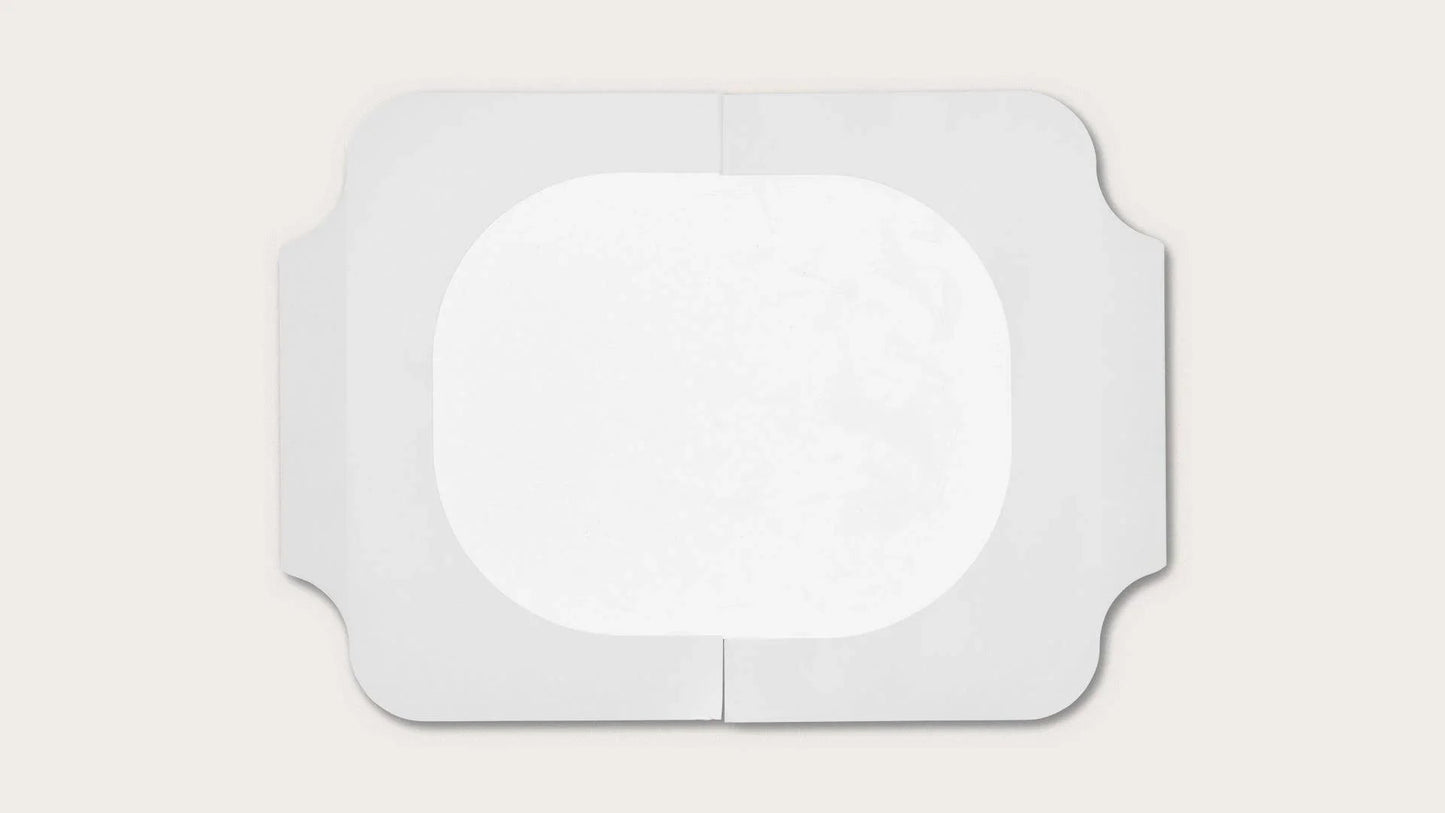 Sterile transparent medical dressing with adhesive border on white background
