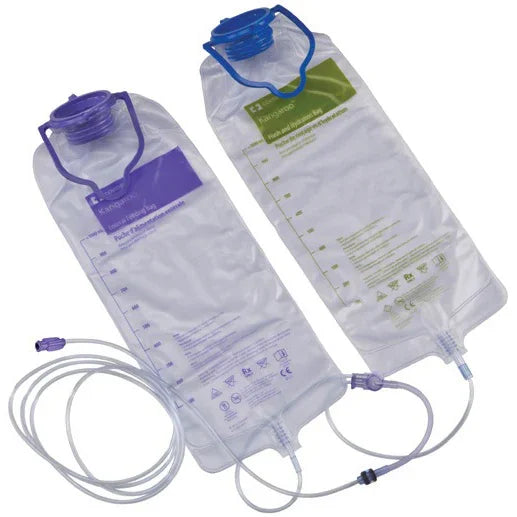 Two transparent medical IV solution bags with purple and green labels, attached tubing