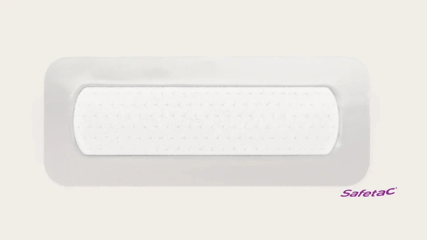 Adhesive wound dressing with soft white pad, rectangular medical bandage, Safetac logo