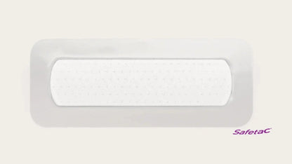 Rectangular white adhesive wound dressing with Safetac logo on a plain background.