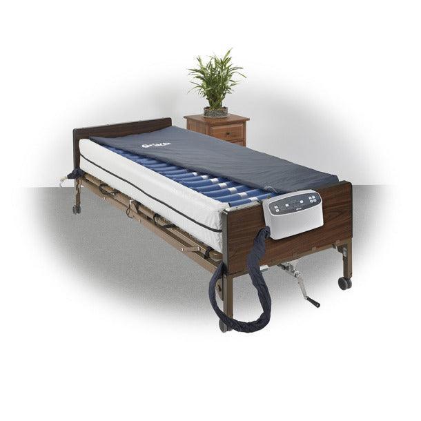 Hospital bed with adjustable air mattress and remote control in a home care setting