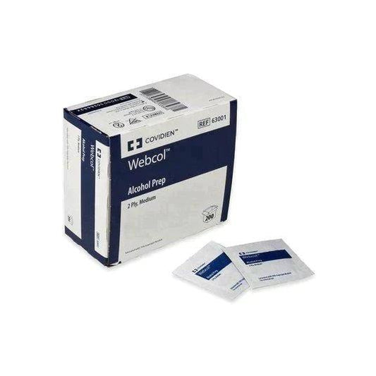 Box of Covidien Webcol alcohol prep pads with two individual sterile wipes placed in front.