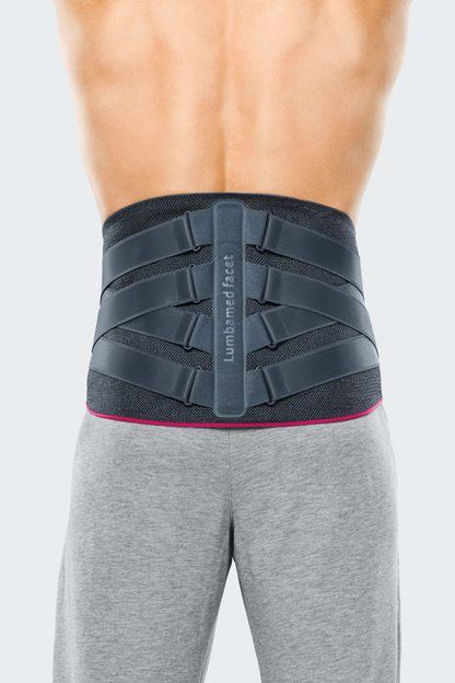 Back view of person wearing gray lumbar support belt for lower back pain relief