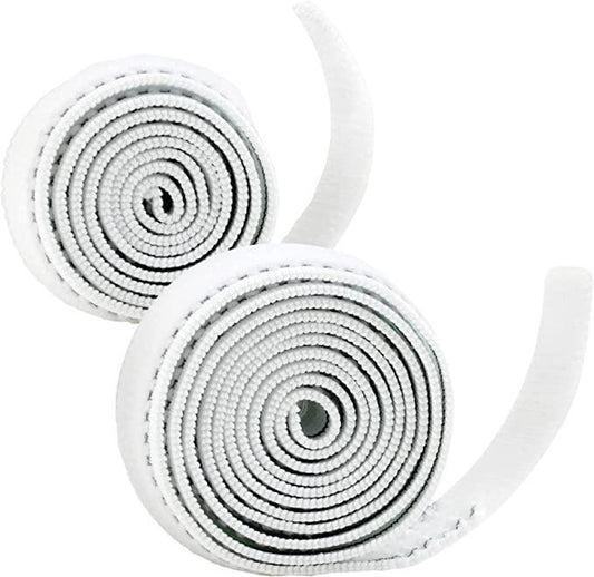 Two white self-adhesive medical bandage rolls, coiled on a white background