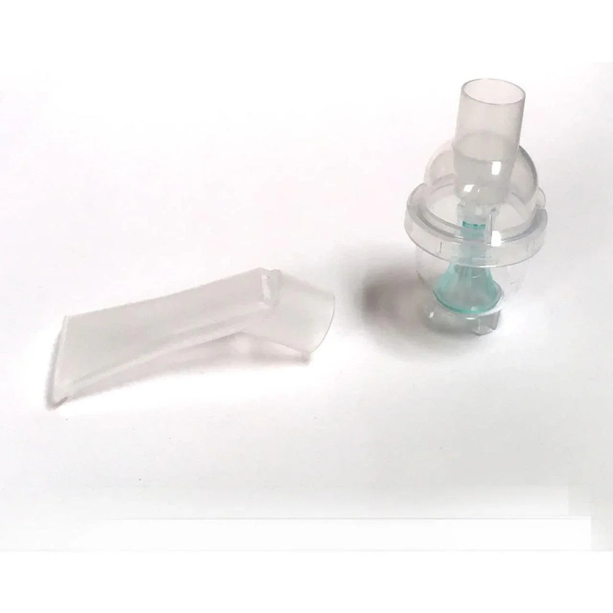 Clear plastic medical nebulizer mouthpiece and chamber on white background