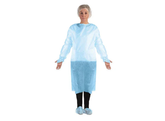 Woman wearing disposable medical isolation gown, shoe covers, and bouffant cap