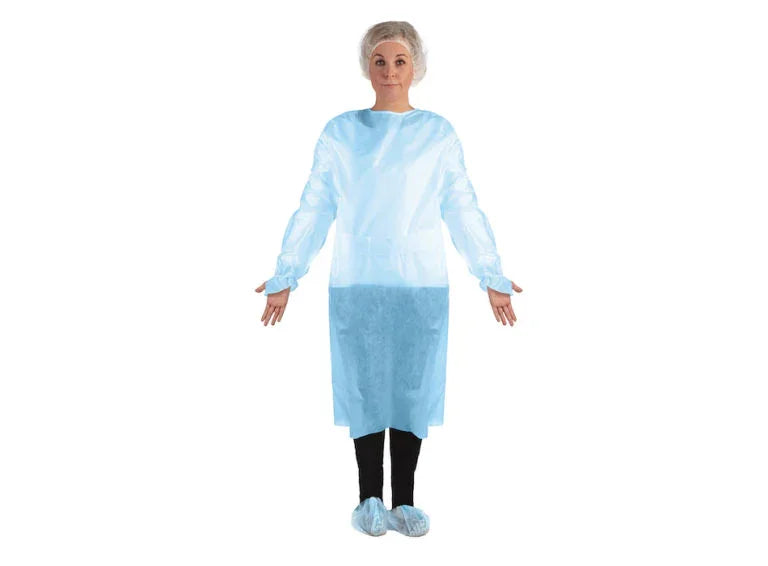 Woman wearing disposable blue medical isolation gown, hair cover, and shoe covers